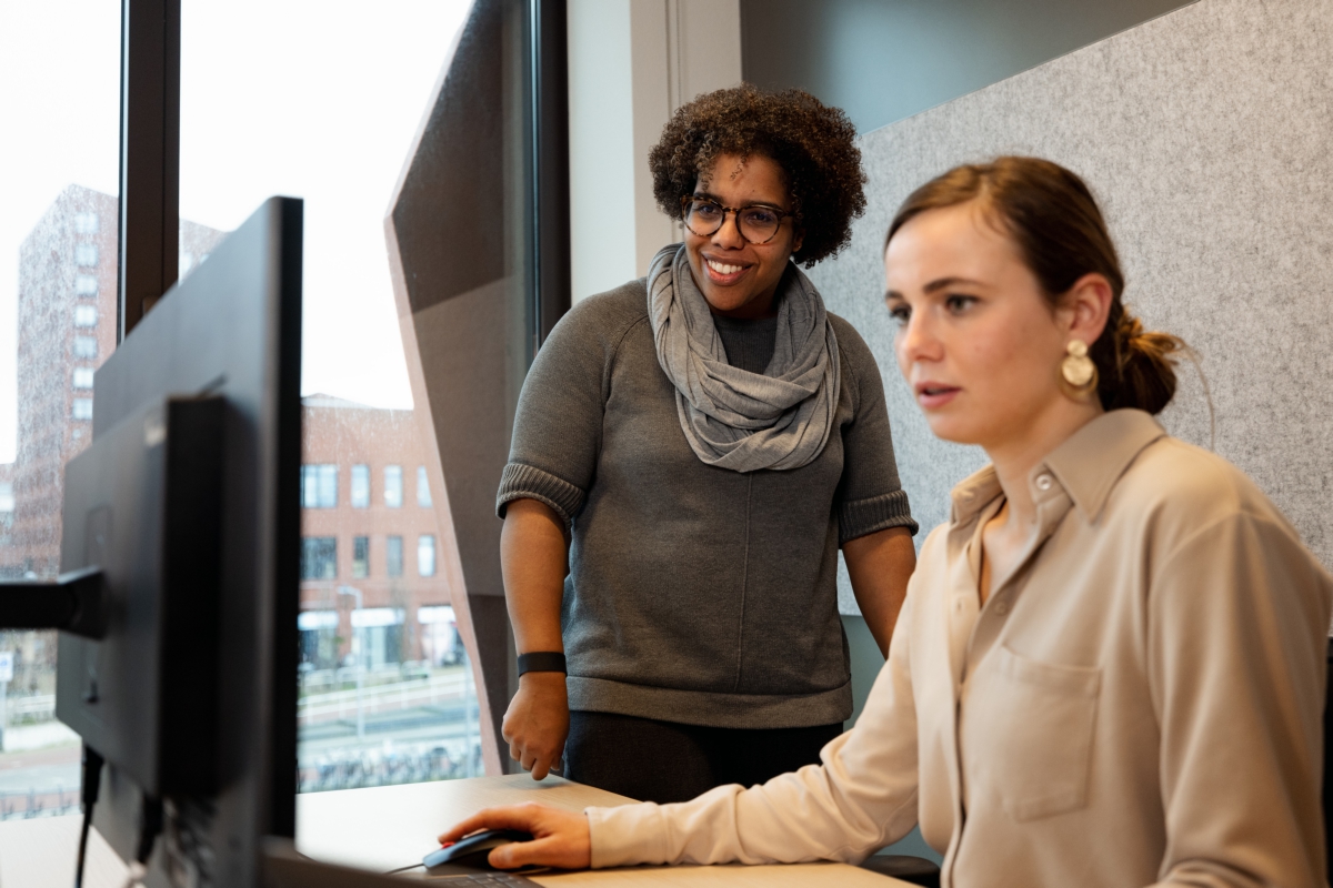 2 CBS employees working behind the computer